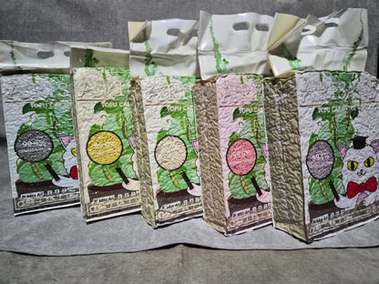 Set of catnip packages with cartoon designs on a gray surface